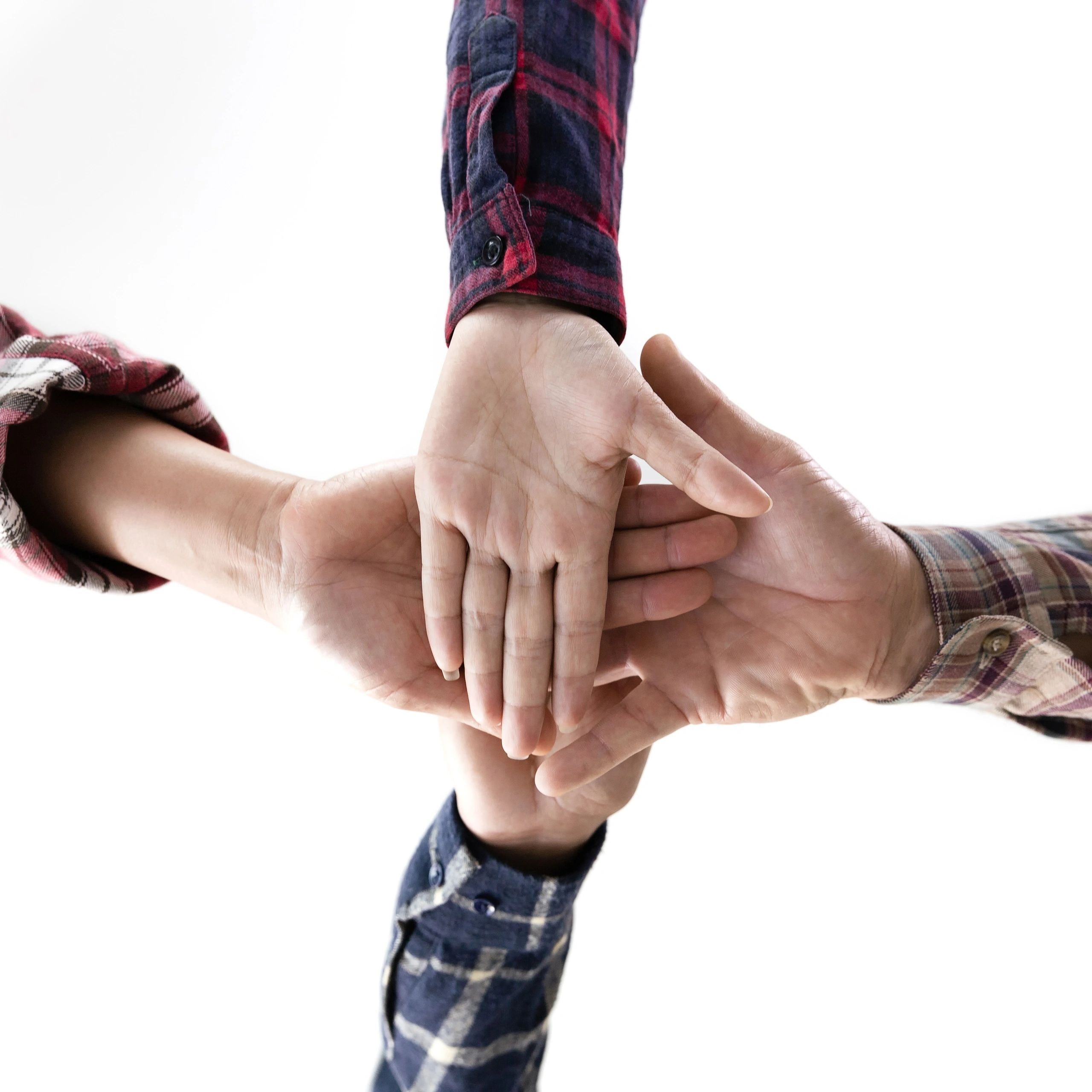 Hands stacked together representing teamwork and unity